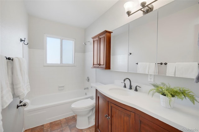 full bathroom featuring vanity, tiled shower / bath, and toilet