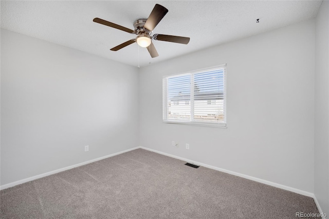 empty room with ceiling fan and carpet