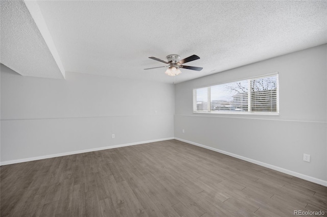 spare room with ceiling fan, wood-type flooring, and a textured ceiling