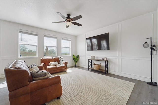 2201 Monte Vista St, Fort Lupton, CO 80621 - living room featuring ceiling fan, wood finished floors, and a decorative wall