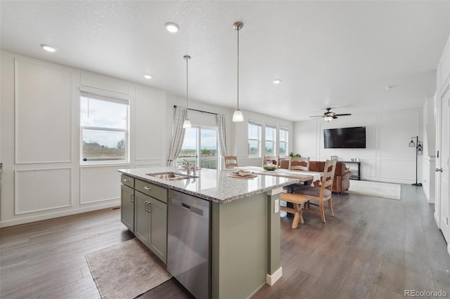 2201 Monte Vista St, Fort Lupton, CO 80621 - kitchen featuring wood finished floors, a sink, a decorative wall, and dishwasher