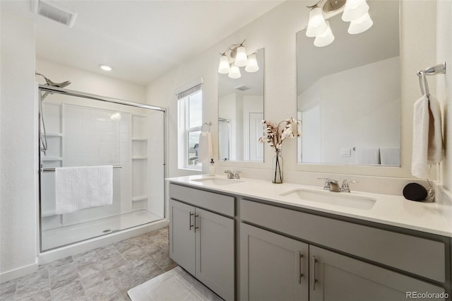 2201 Monte Vista St, Fort Lupton, CO 80621 - full bath featuring a sink, a stall shower, and a notable chandelier