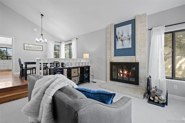 living area with an inviting chandelier, vaulted ceiling, and a wealth of natural light