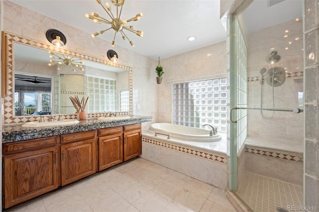 bathroom with a garden tub, a sink, double vanity, and a shower stall