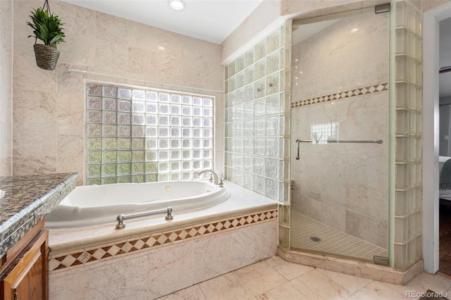 full bath featuring a bath, tile walls, a shower stall, vanity, and tile patterned floors