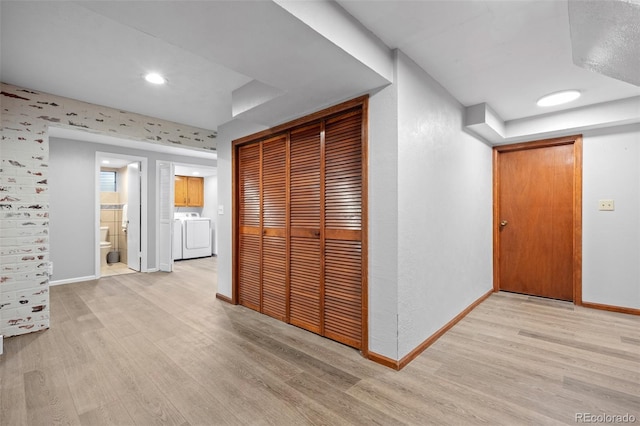 corridor with recessed lighting, baseboards, washing machine and dryer, and light wood-style flooring