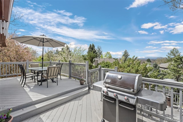 wooden terrace featuring outdoor dining area and area for grilling
