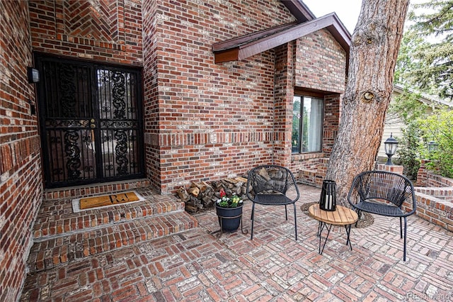 property entrance featuring brick siding