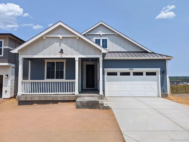 8326 Cokedale Cir, Littleton, CO 80125 - view of front of property featuring covered porch, an attached garage, board and batten siding, a standing seam roof, and concrete driveway