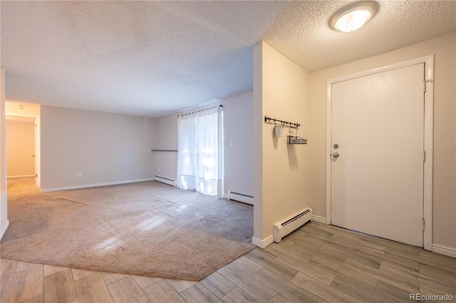 entrance foyer featuring a textured ceiling, light hardwood / wood-style flooring, and baseboard heating