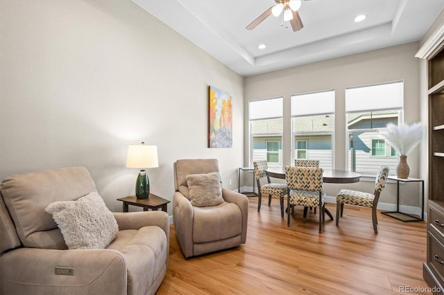 living area with recessed lighting, light wood-style flooring, baseboards, and a ceiling fan
