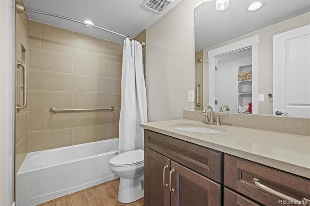 full bathroom featuring visible vents, shower / bath combination with curtain, toilet, vanity, and wood finished floors