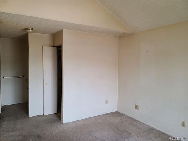 4760 S Wadsworth Unit 301, Littleton, CO 80123 - carpeted empty room with a textured ceiling, lofted ceiling, and baseboards