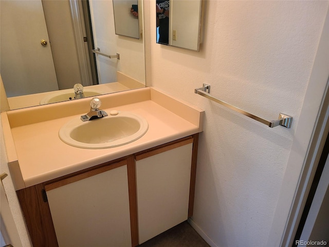 4760 S Wadsworth Unit 301, Littleton, CO 80123 - bathroom with vanity and a textured wall