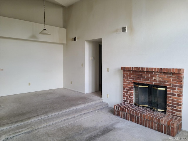 4760 S Wadsworth Unit 301, Littleton, CO 80123 - unfurnished living room featuring carpet, a fireplace, a towering ceiling, and baseboards