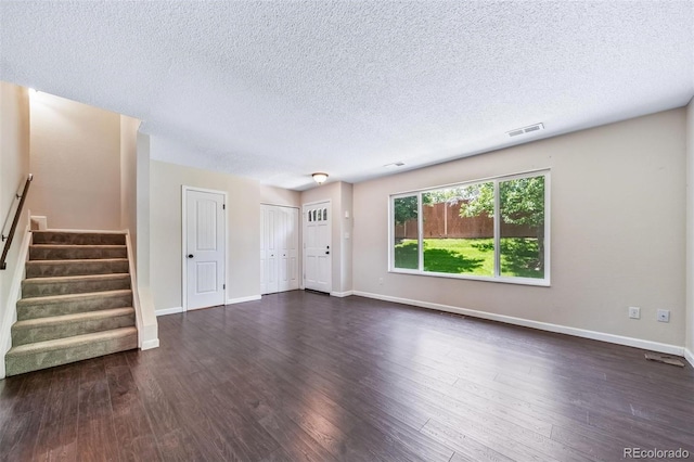 3806 S Yosemite St, Denver, CO 80237 - unfurnished living room featuring stairway, a textured ceiling, baseboards, and dark wood-style flooring