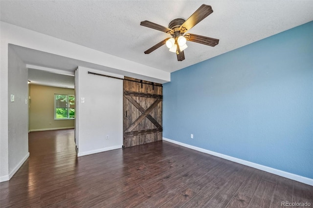 3806 S Yosemite St, Denver, CO 80237 - empty room with a barn door, wood finished floors, a ceiling fan, baseboards, and a textured ceiling