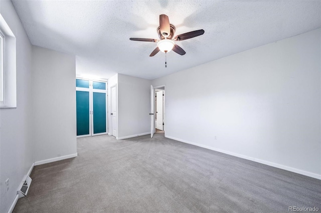 3806 S Yosemite St, Denver, CO 80237 - carpeted spare room featuring a ceiling fan, a textured ceiling, and baseboards