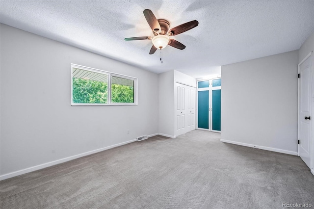 3806 S Yosemite St, Denver, CO 80237 - unfurnished bedroom with a textured ceiling, carpet, baseboards, and a ceiling fan