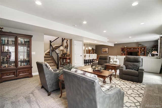 15804 Elizabeth Cir E, Thornton, CO 80602 - living room featuring light carpet, recessed lighting, stairs, a chandelier, and baseboards