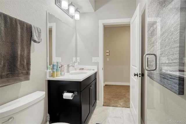 15804 Elizabeth Cir E, Thornton, CO 80602 - bathroom featuring vanity, toilet, and marble finish floors