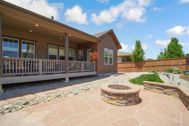 15804 Elizabeth Cir E, Thornton, CO 80602 - porch with an outdoor fire pit and a patio area