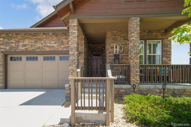 15804 Elizabeth Cir E, Thornton, CO 80602 - property entrance featuring concrete driveway, a garage, and covered porch