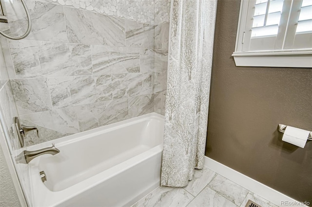 15804 Elizabeth Cir E, Thornton, CO 80602 - full bathroom featuring shower / bath combo, marble look tiles, baseboards, and a textured wall