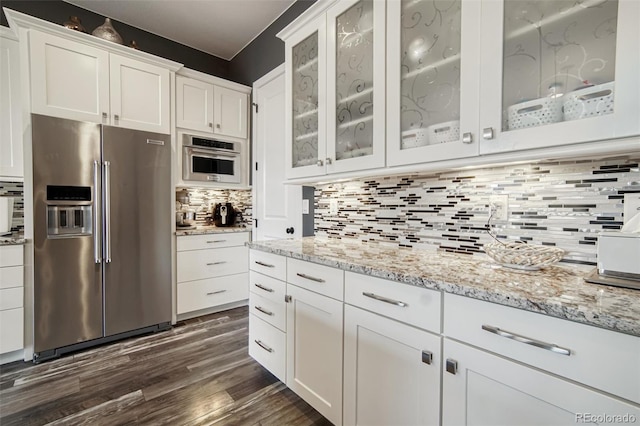 15804 Elizabeth Cir E, Thornton, CO 80602 - kitchen featuring stainless steel fridge with ice dispenser, white cabinets, backsplash, dark wood-type flooring, and light stone countertops
