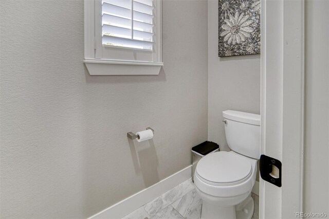 15804 Elizabeth Cir E, Thornton, CO 80602 - bathroom with toilet and marble look tiles