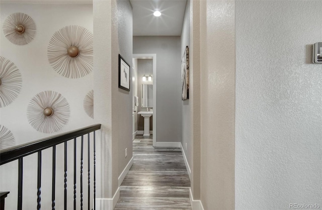 15804 Elizabeth Cir E, Thornton, CO 80602 - hallway with wood finished floors, baseboards, a sink, and a textured wall