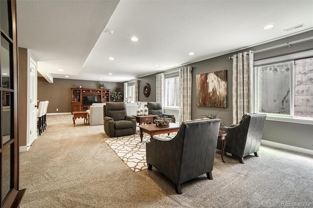15804 Elizabeth Cir E, Thornton, CO 80602 - living area with light colored carpet, baseboards, recessed lighting, and a glass covered fireplace