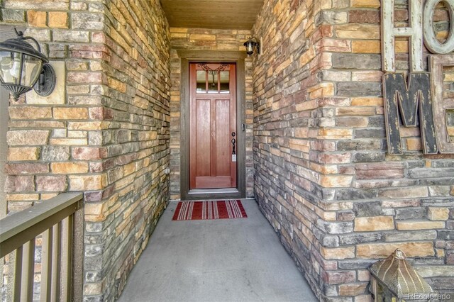 15804 Elizabeth Cir E, Thornton, CO 80602 - property entrance featuring brick siding and covered porch