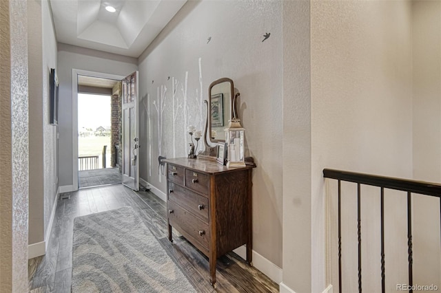 15804 Elizabeth Cir E, Thornton, CO 80602 - hall featuring dark wood-style floors, baseboards, a textured wall, and a raised ceiling