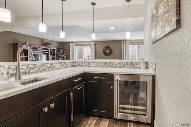 15804 Elizabeth Cir E, Thornton, CO 80602 - bar area with wine cooler, a textured wall, decorative backsplash, a sink, and wood finished floors