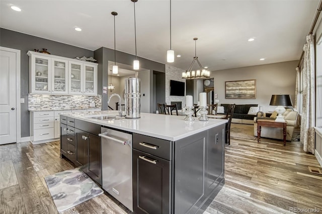 15804 Elizabeth Cir E, Thornton, CO 80602 - kitchen featuring dishwasher, light wood-style flooring, open floor plan, light countertops, and white cabinetry