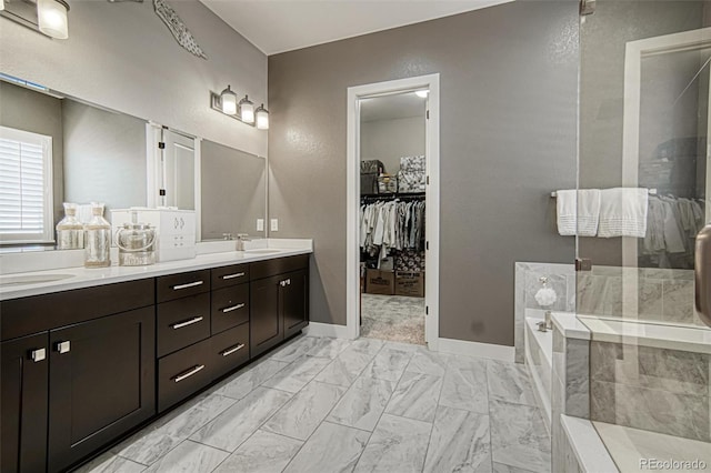 15804 Elizabeth Cir E, Thornton, CO 80602 - bathroom featuring double vanity, a bath, marble finish flooring, a spacious closet, and a shower