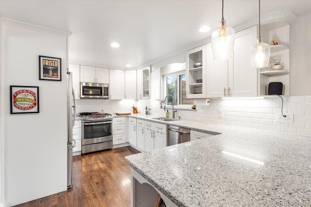 10833 W 61st Ave, Arvada, CO 80004 - kitchen with appliances with stainless steel finishes, open shelves, light stone counters, white cabinets, and recessed lighting
