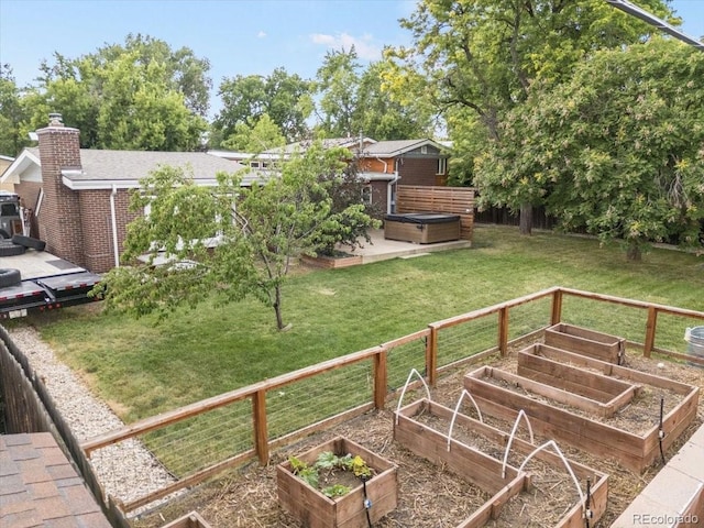 10833 W 61st Ave, Arvada, CO 80004 - view of green lawn featuring a vegetable garden, a patio area, and a hot tub