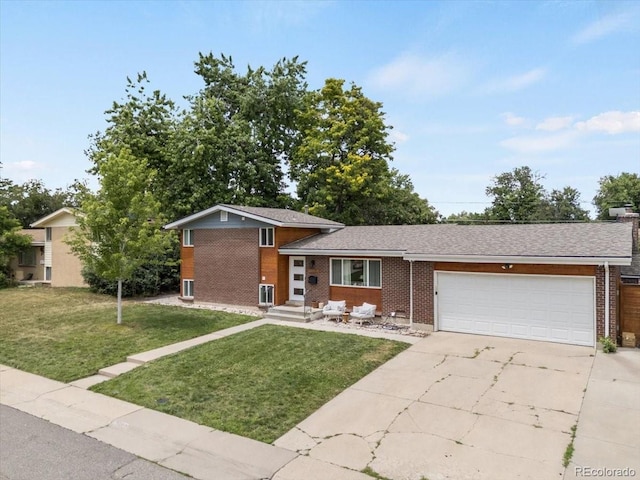10833 W 61st Ave, Arvada, CO 80004 - tri-level home featuring brick siding, an attached garage, driveway, and a front lawn