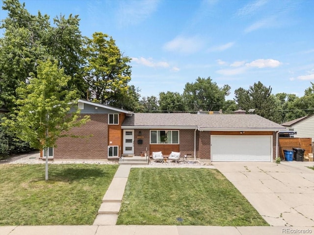 10833 W 61st Ave, Arvada, CO 80004 - view of front facade featuring brick siding, a garage, driveway, and a front lawn
