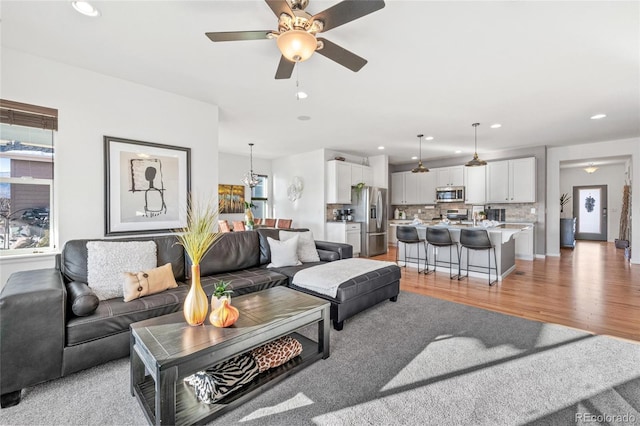 living room with ceiling fan and hardwood / wood-style floors