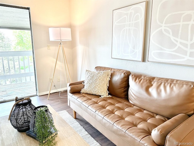 living area with wood finished floors and baseboards