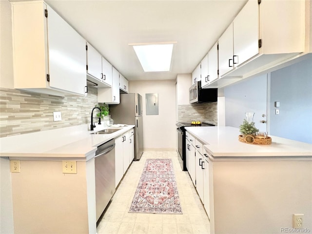 kitchen with stainless steel appliances, a sink, backsplash, light countertops, and electric panel
