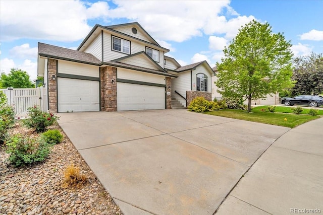 5286 Rustic Ave, Firestone, CO 80504 - traditional home featuring a garage, stone siding, driveway, and roof with shingles