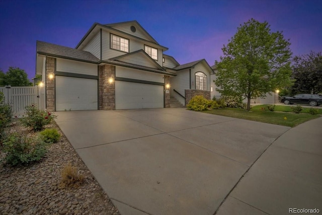 5286 Rustic Ave, Firestone, CO 80504 - traditional-style house featuring an attached garage, stone siding, and driveway