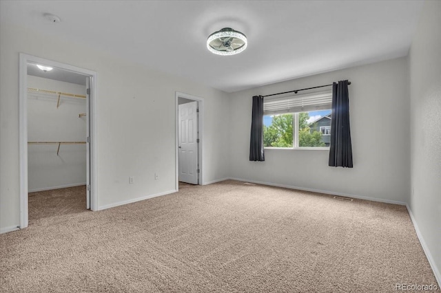 5286 Rustic Ave, Firestone, CO 80504 - unfurnished bedroom featuring carpet floors, a spacious closet, baseboards, and a closet