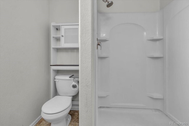 5286 Rustic Ave, Firestone, CO 80504 - bathroom featuring toilet, a shower, and baseboards