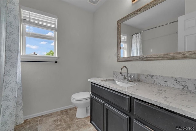 5286 Rustic Ave, Firestone, CO 80504 - full bathroom featuring vanity, plenty of natural light, toilet, and baseboards