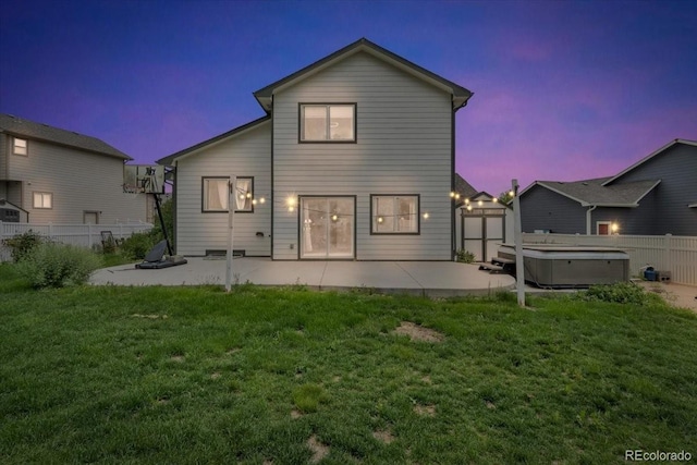 5286 Rustic Ave, Firestone, CO 80504 - back of property at dusk featuring a hot tub and a patio area